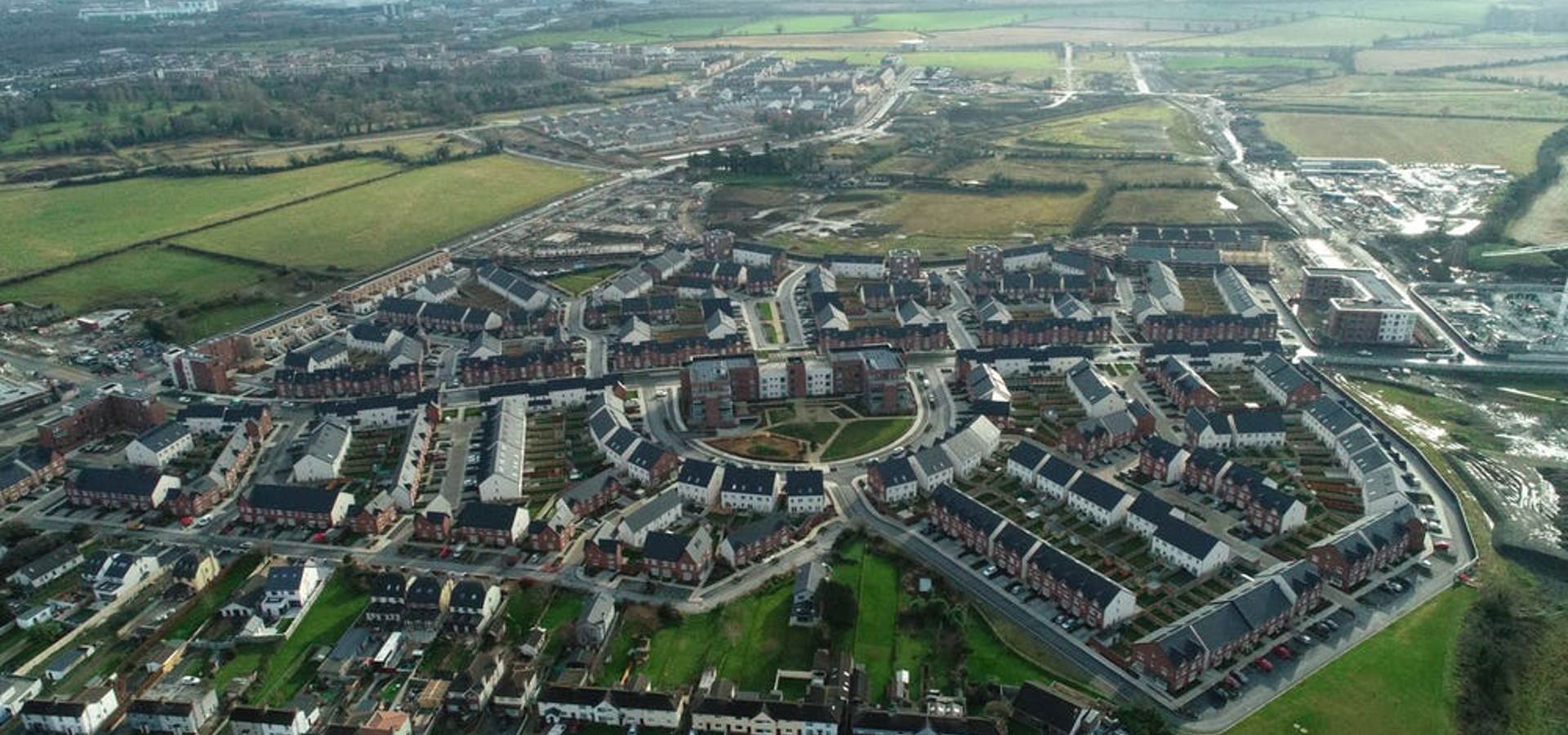 Aerial view of a completed housing estate surrounded by farmland