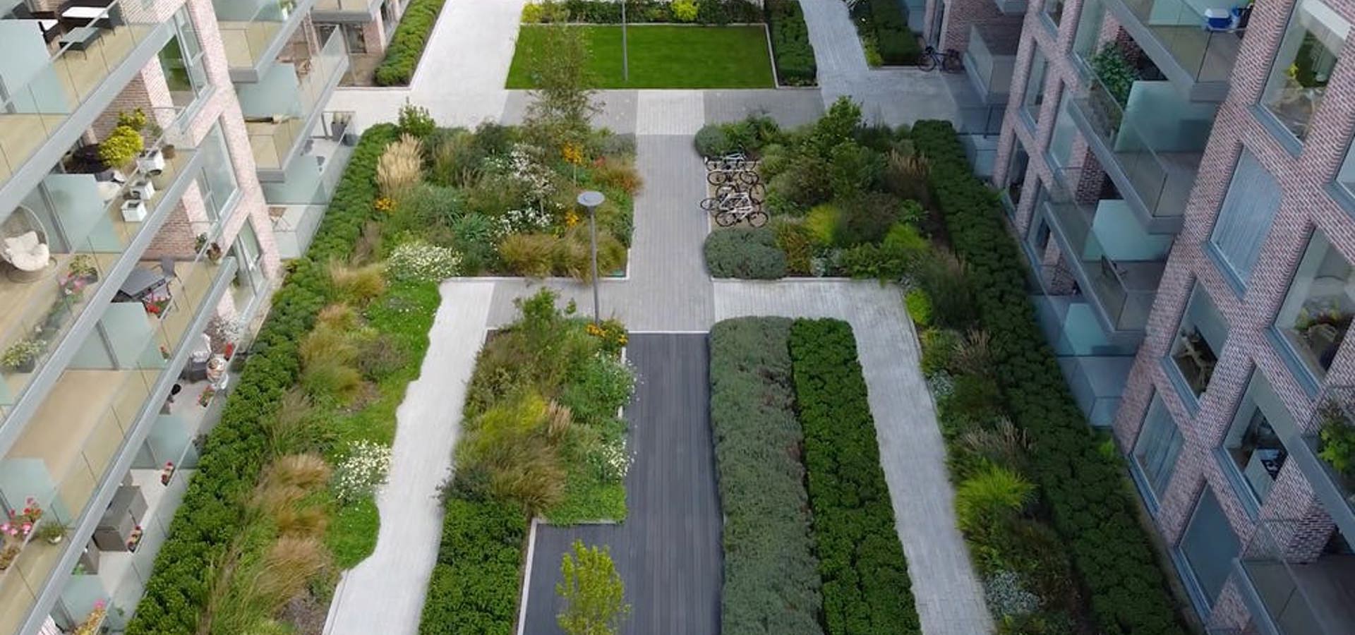 Aerial view of the landscaped courtyard gardens between apartment blocks at Marianella