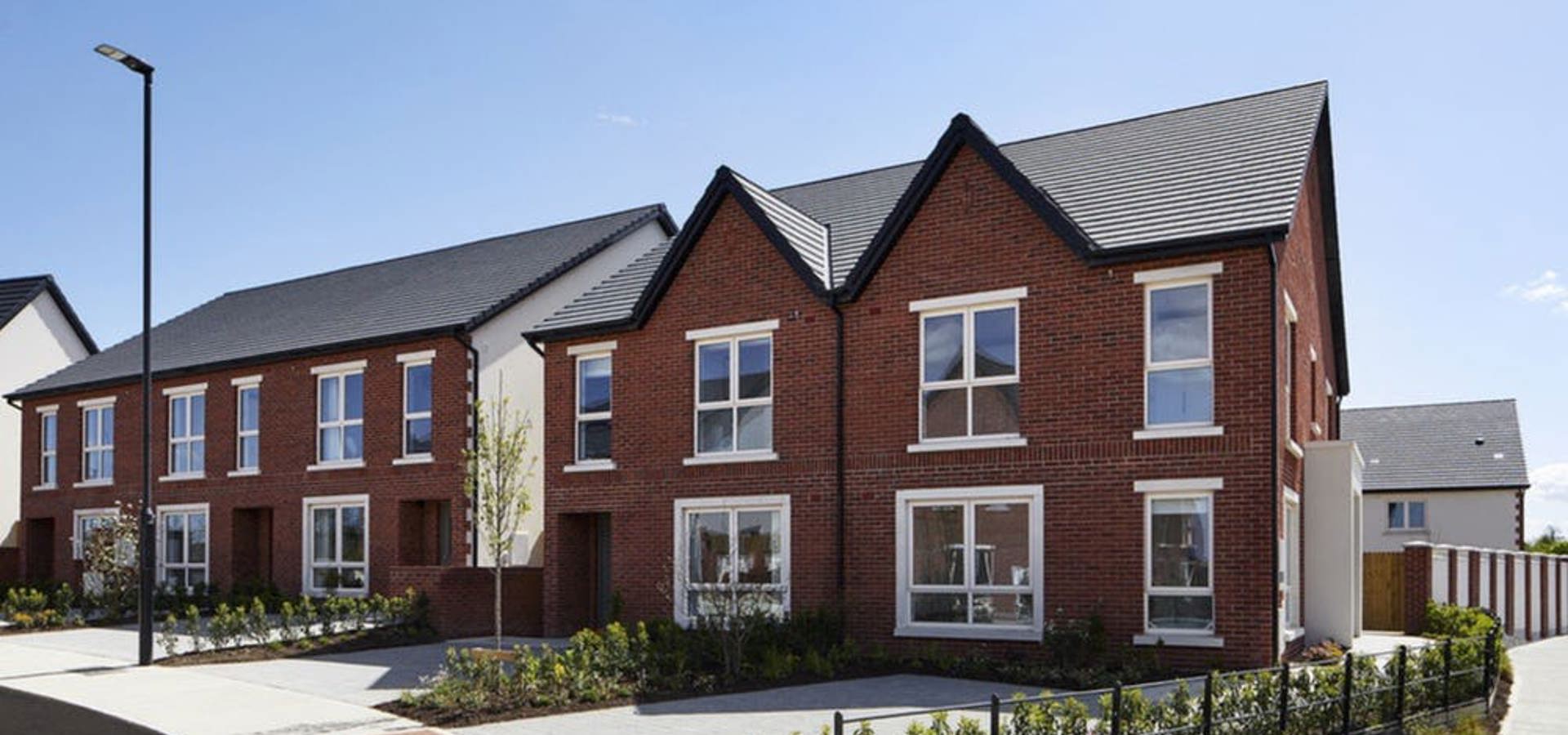 Newly built brick semi-detached homes on a completed Cairn street