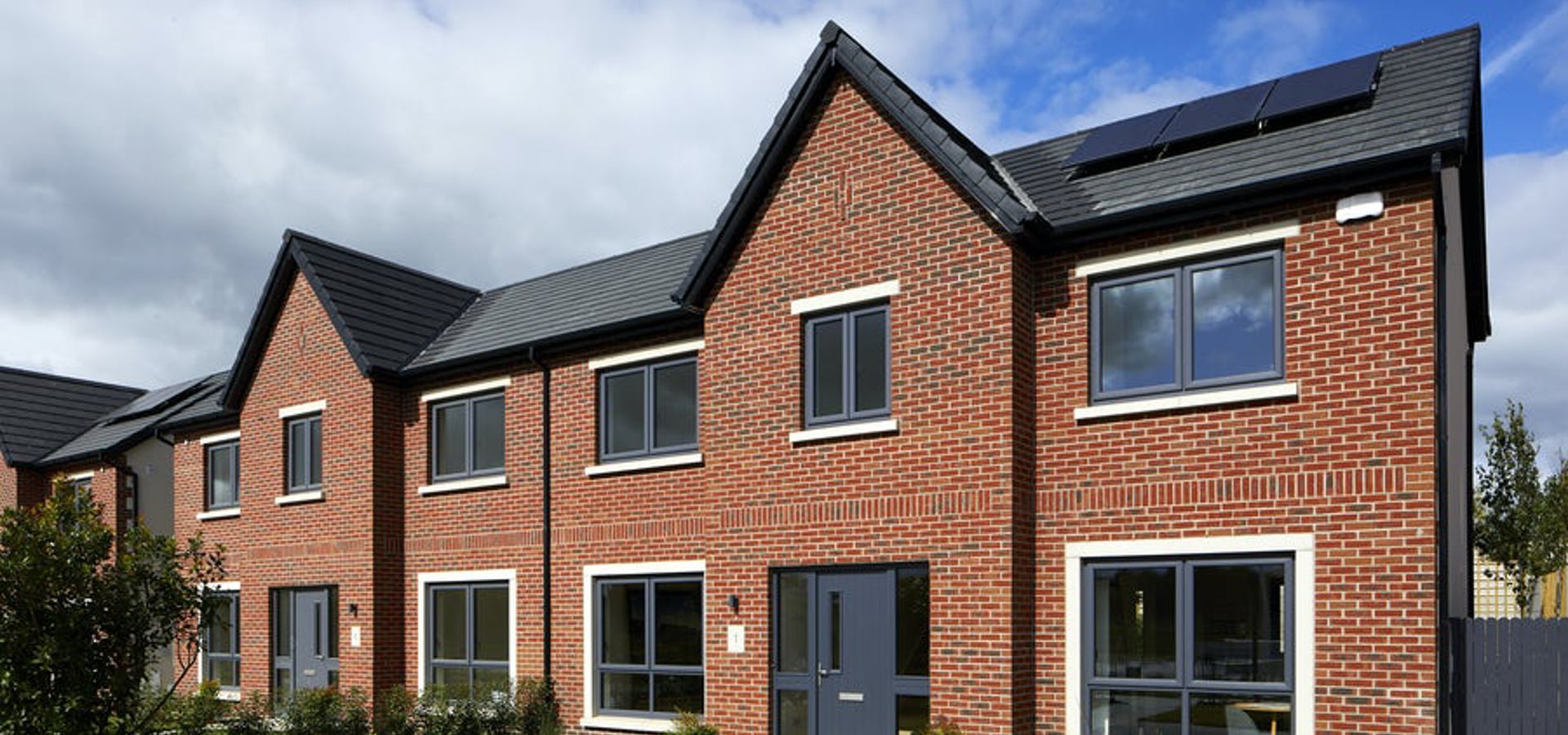 Newly completed pair of brick semi-detached homes at a Cairn development