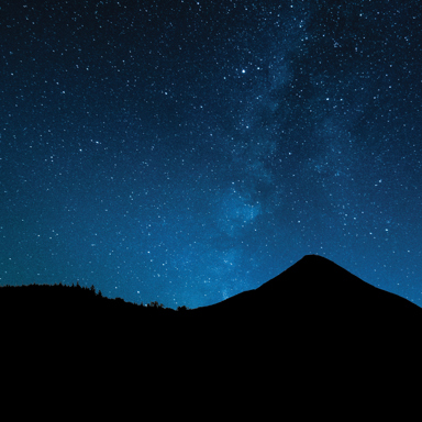 Starry night sky above the silhouette of a conical mountain near Delgany, County Wicklow