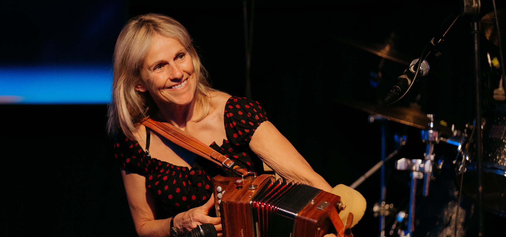 Musician playing an accordion on stage at Cairn's 2021 subcontractor evening