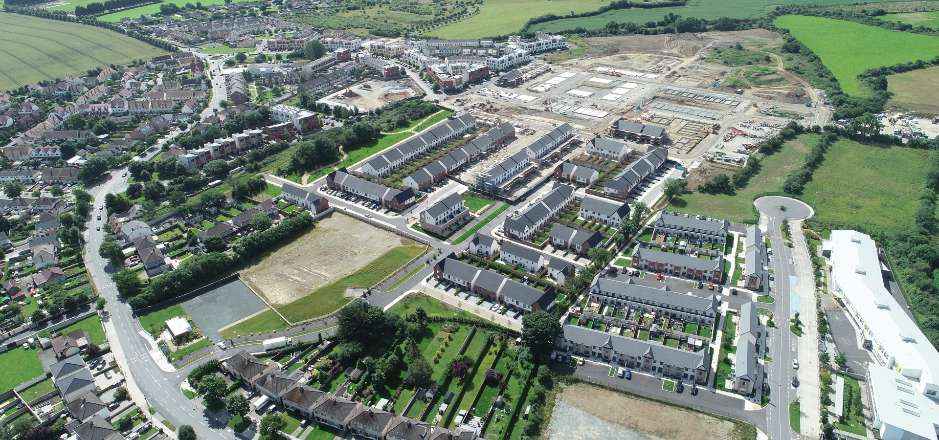 Aerial view of a large housing development beside open fields